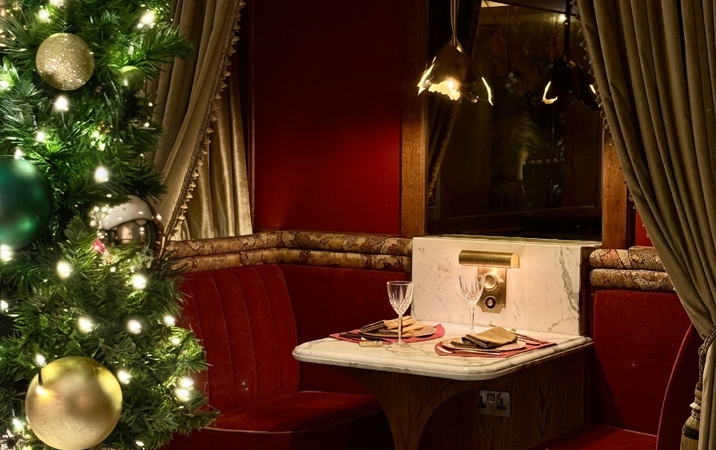 a table with a christmas tree in the background