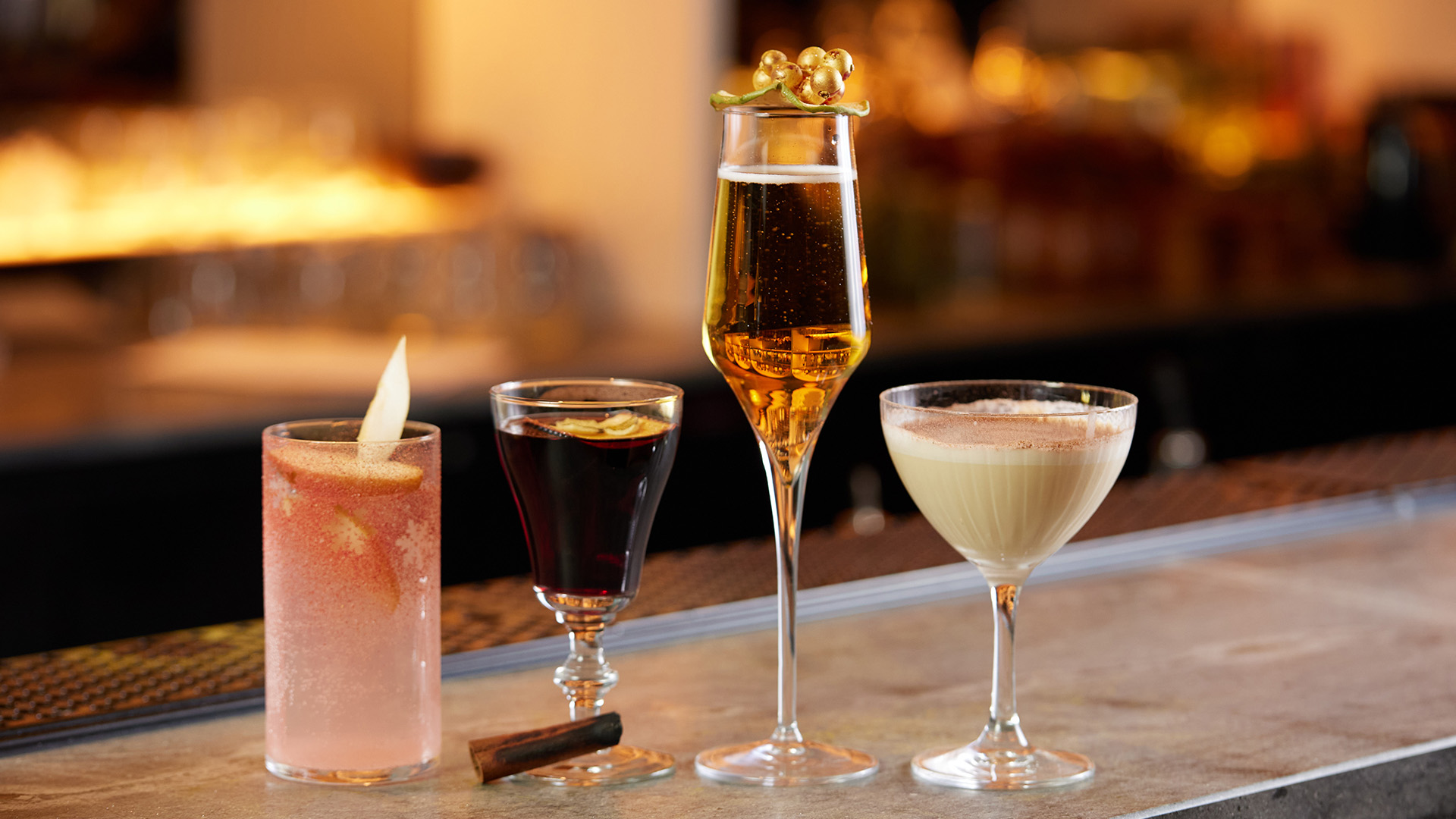 a group of different drinks on a bar