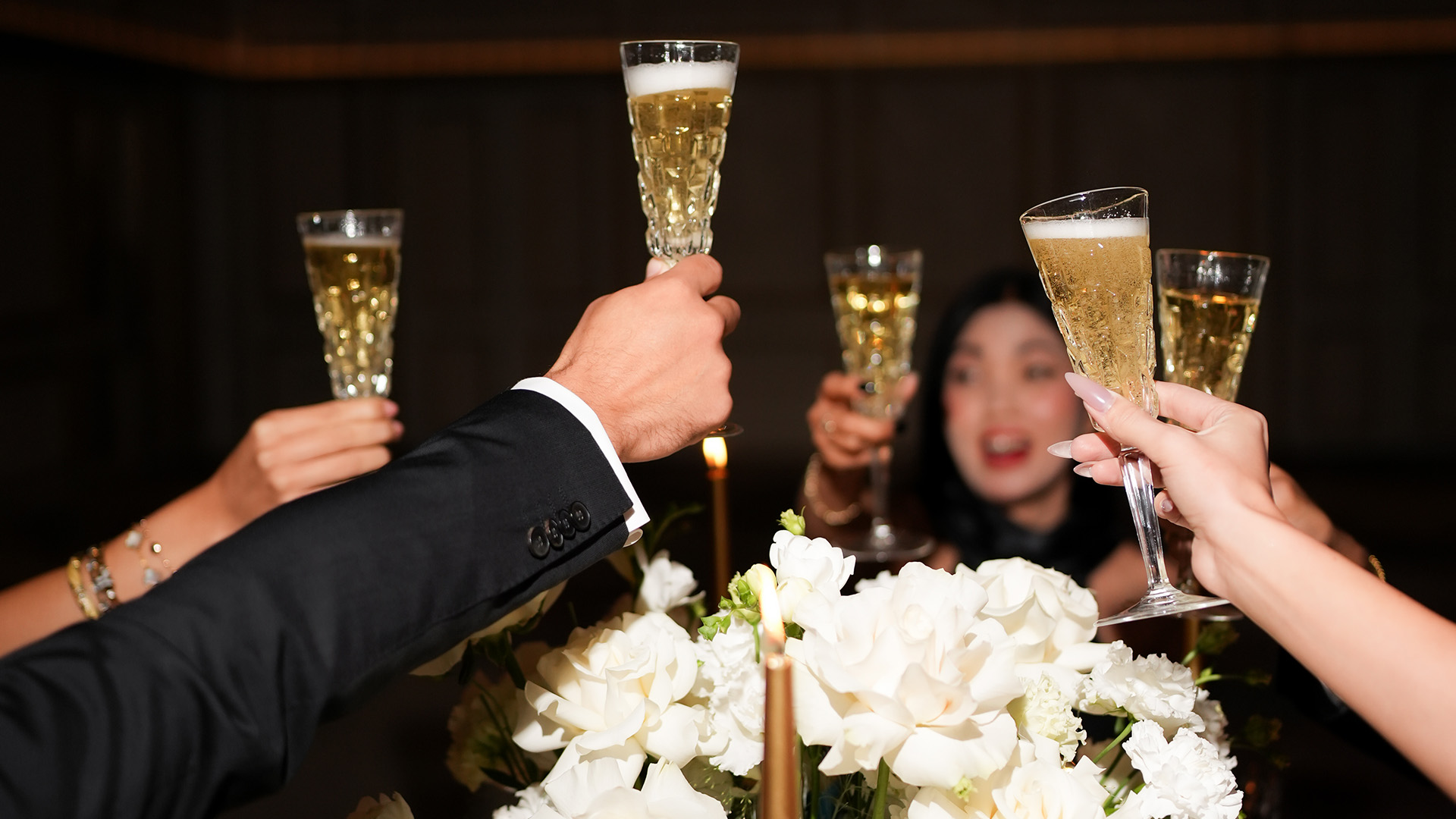 a group of people holding champagne glasses