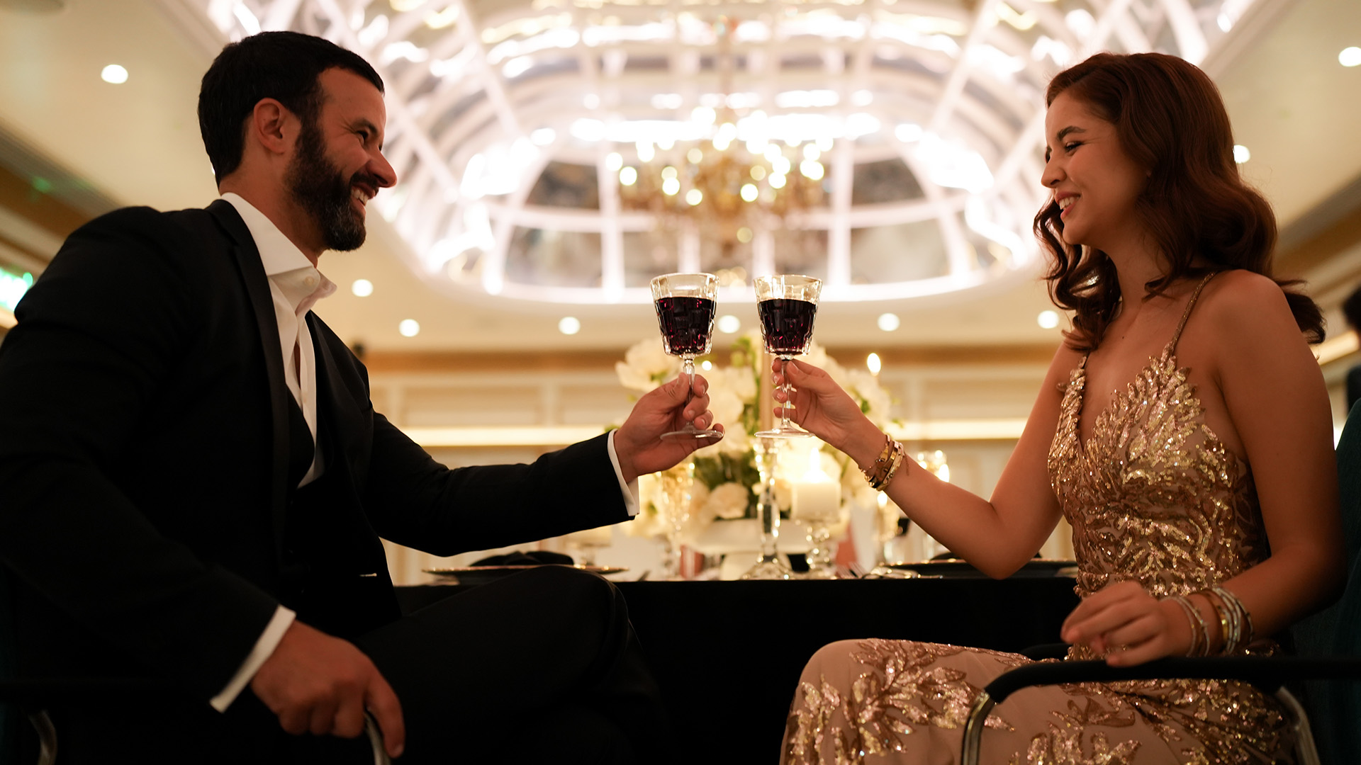 a man and woman holding wine glasses