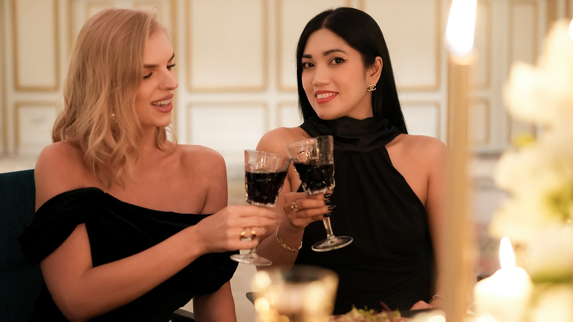 two women holding wine glasses