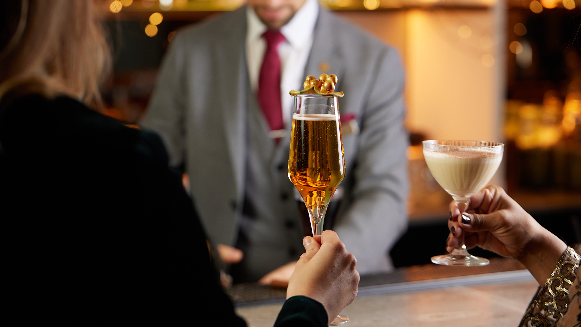 a person holding a glass of champagne