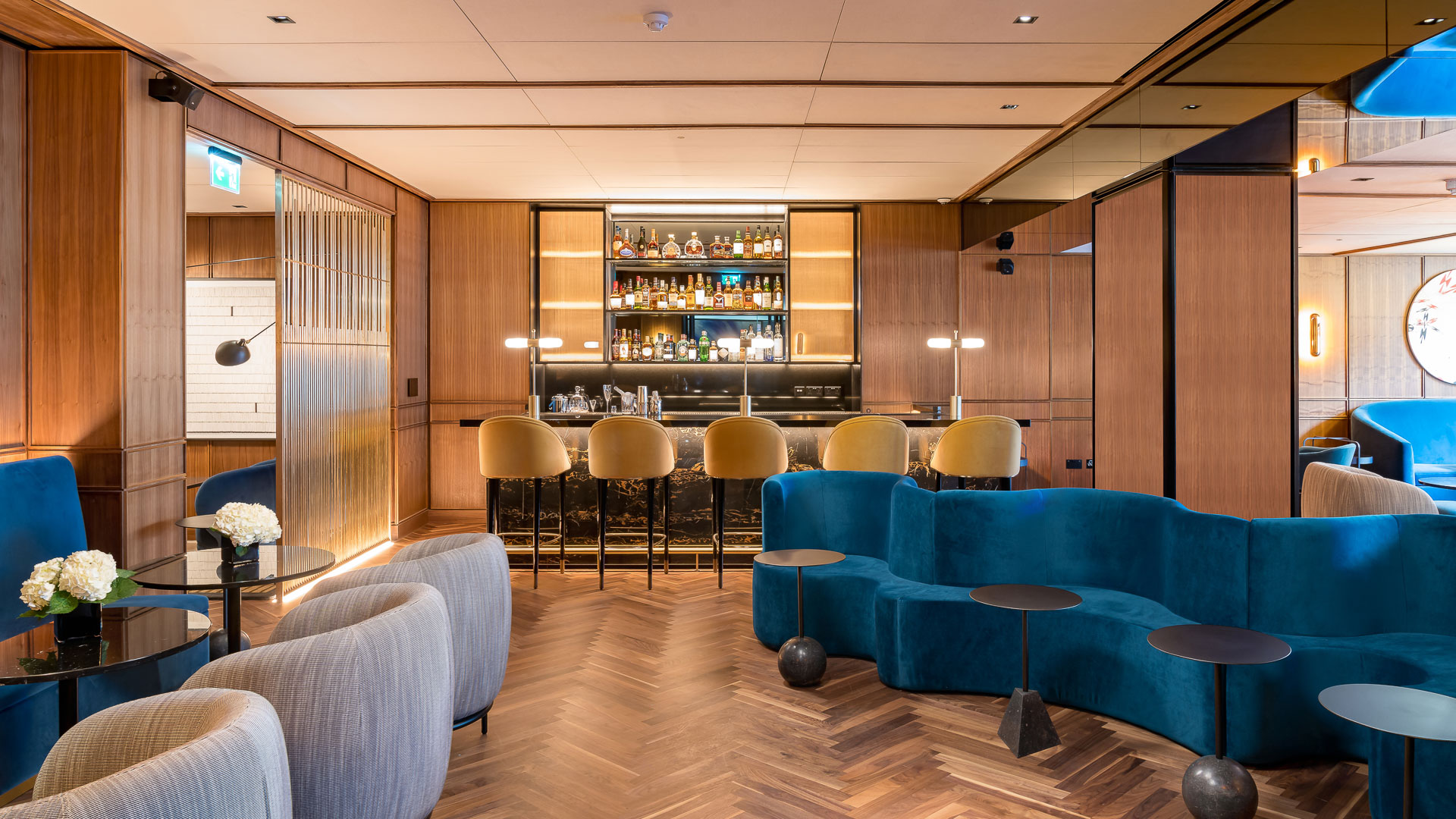 a room with a bar and a blue couch
