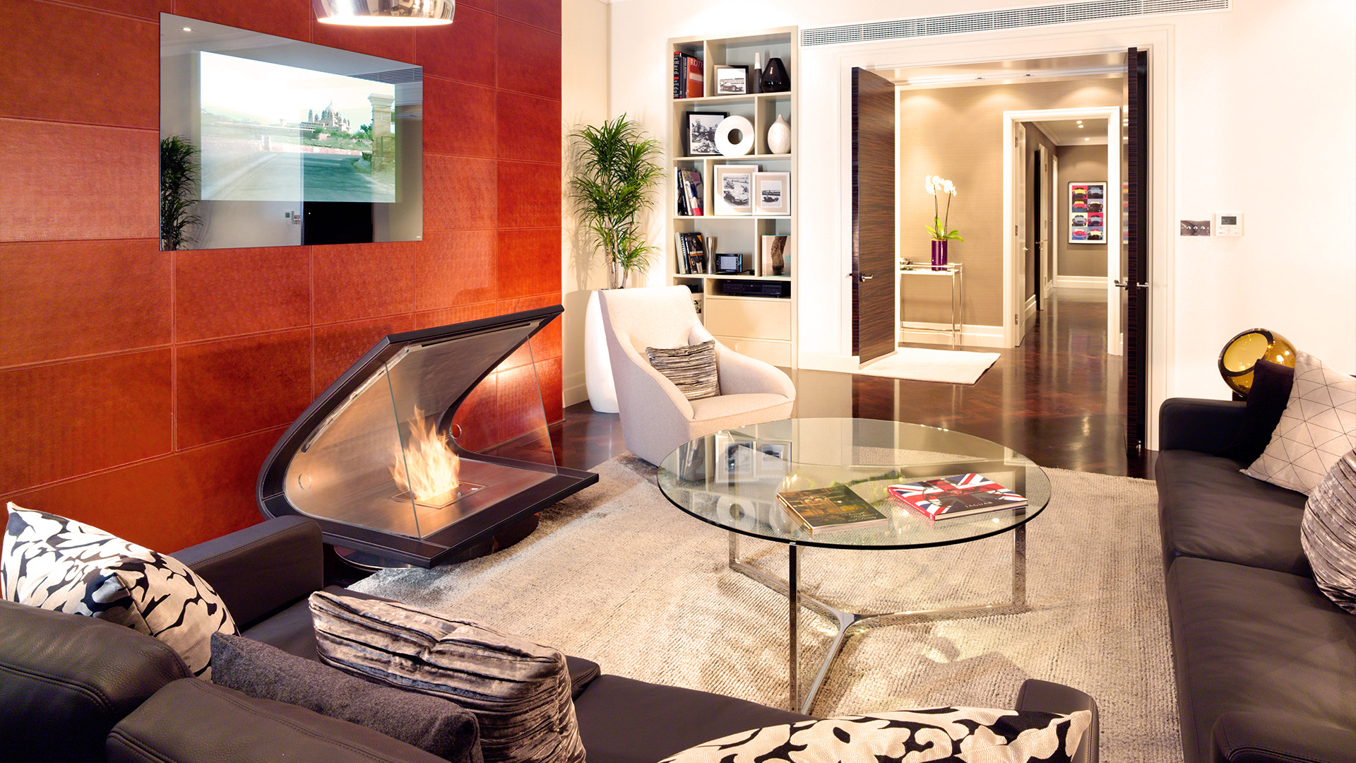 a living room with a fireplace and a glass table