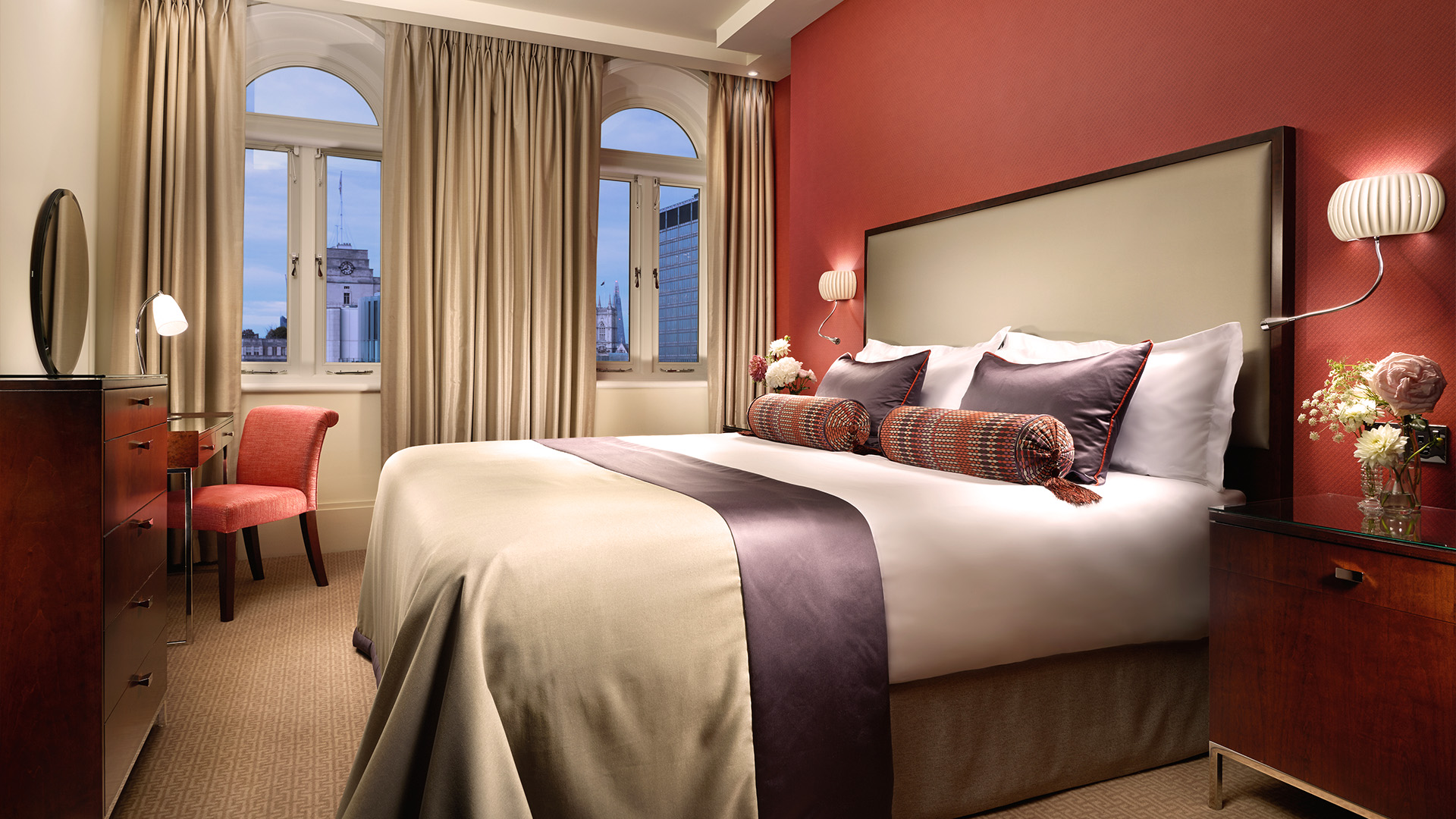 a bed with pillows in a room with red walls