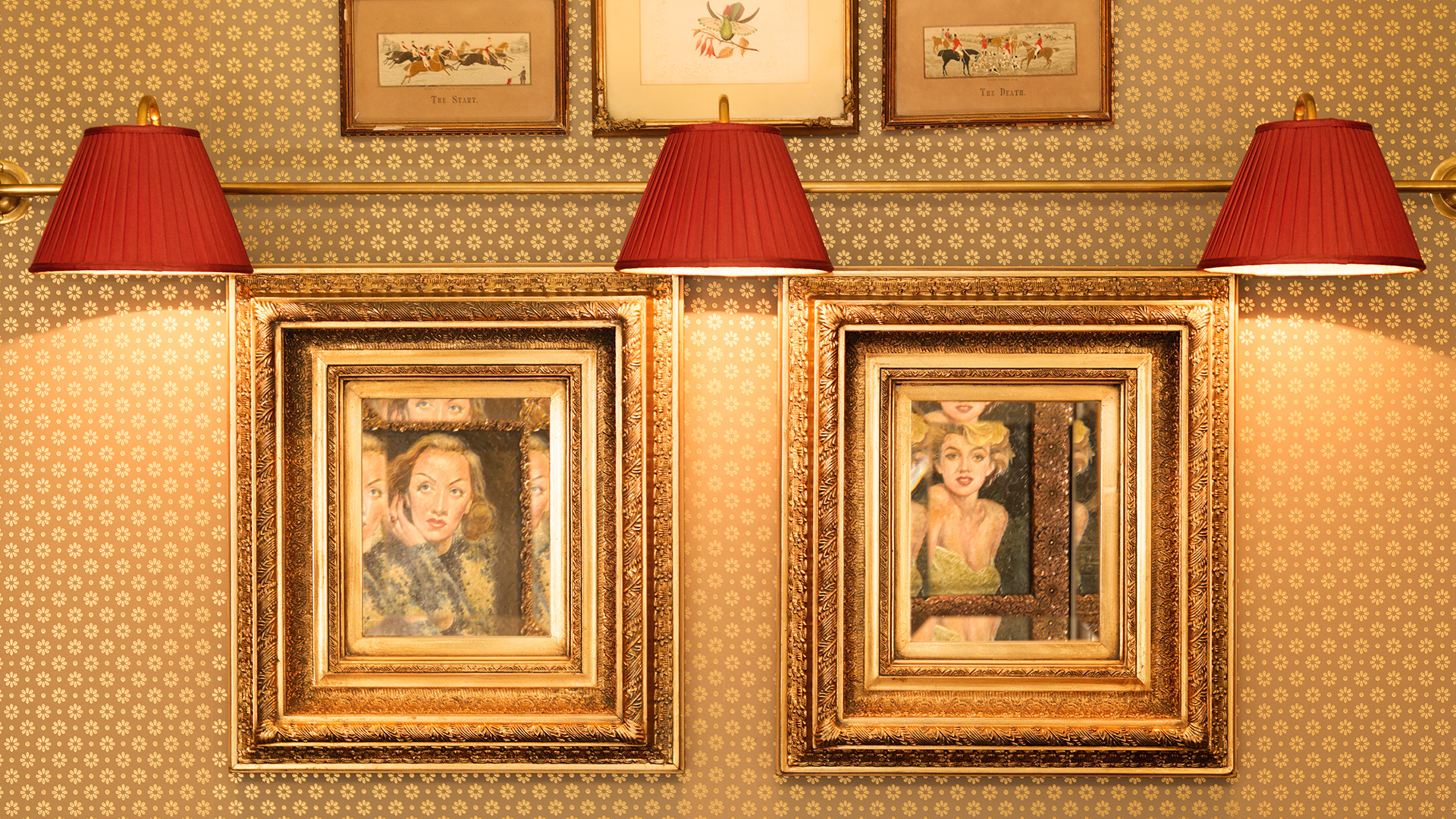 a group of framed pictures on a wall