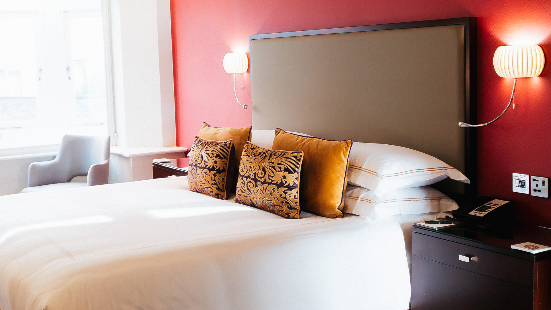 a bed with pillows and a lamp