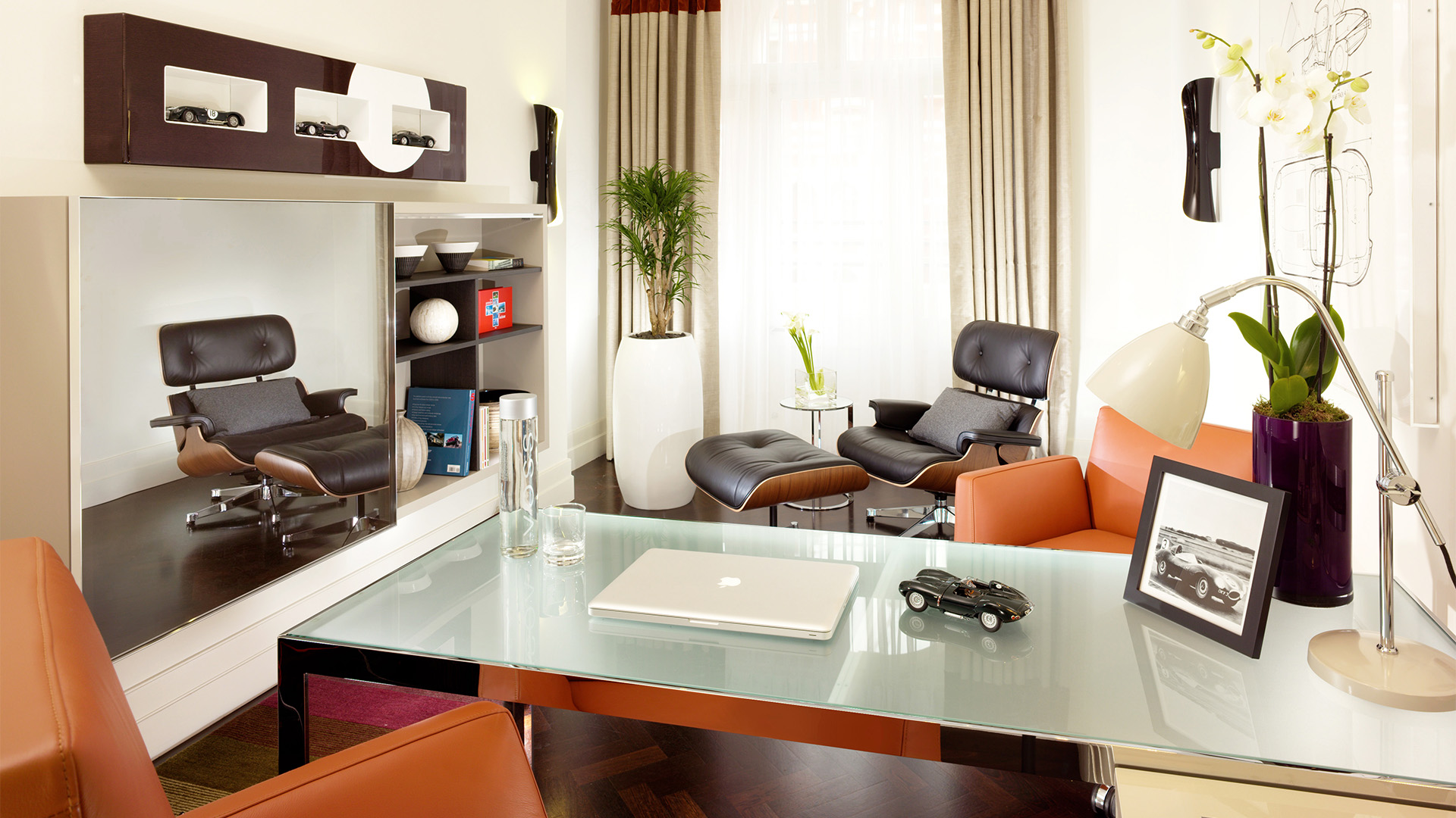 a room with a glass table and chairs