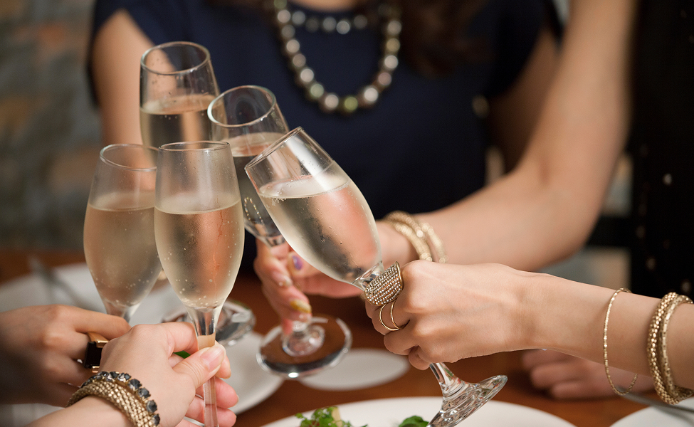a group of people holding champagne glasses