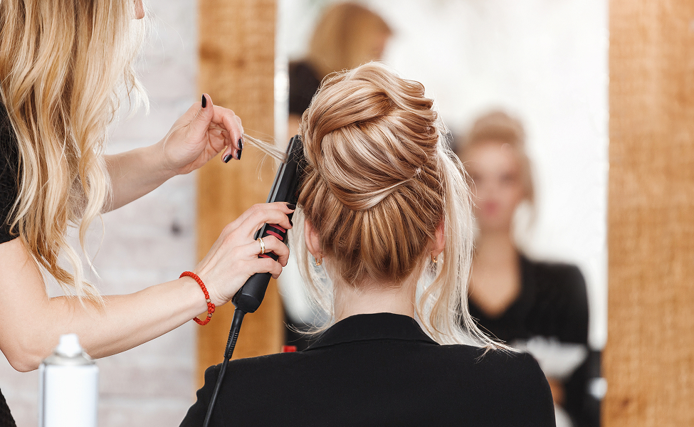 a woman curling her hair