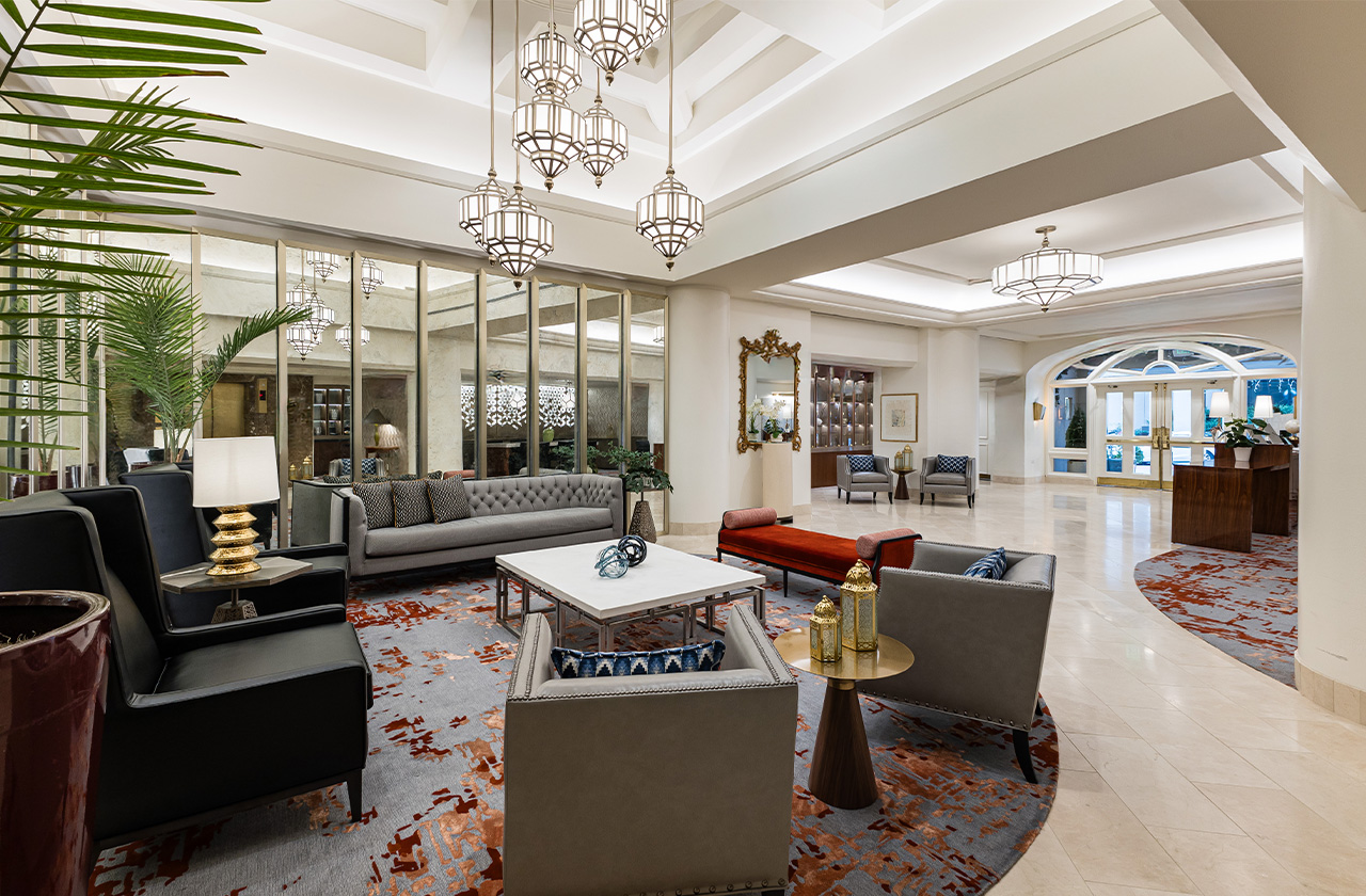 a large room with a large chandelier and couches