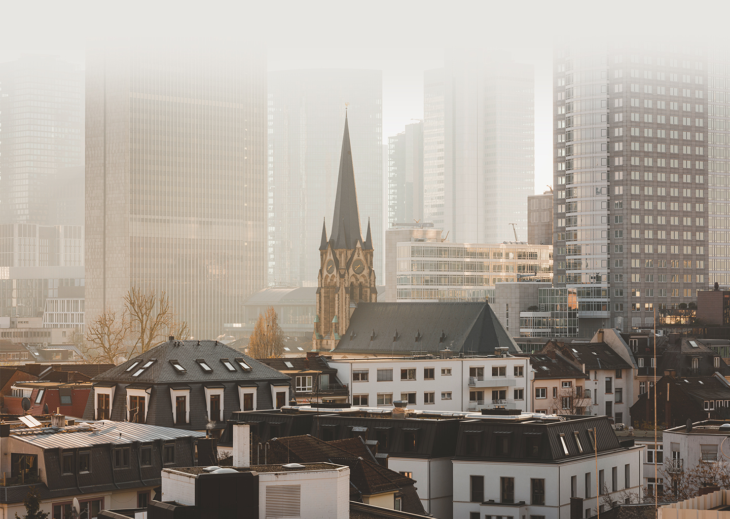 a city with a tall building and a church