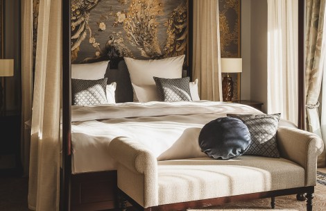 a bed with pillows and a couch in a room