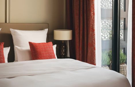 a bed with a lamp next to a window