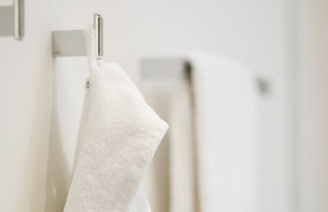 a white towel from a metal rack