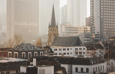 a city with tall buildings and a church