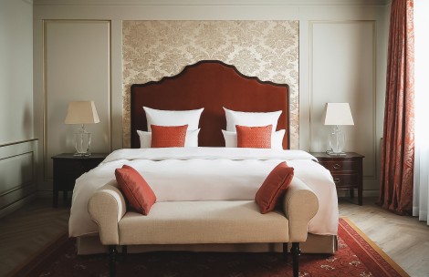a bed with a couch and two lamps