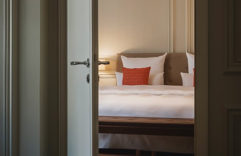 a bed with pillows and a bed bench