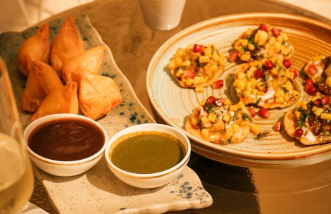 a plate of food with sauces and a bowl of dip