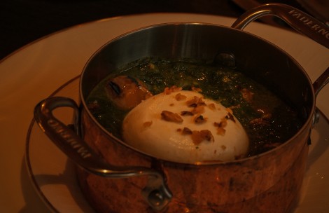 a pot of soup with a white ball in it