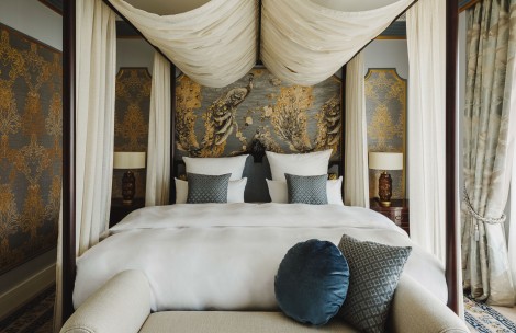 a bed with white sheets and pillows