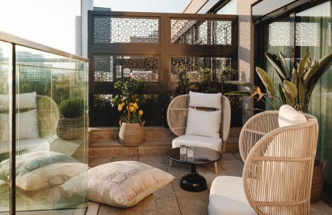 a patio with chairs and a table