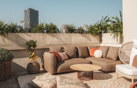a couch and pillows on a patio