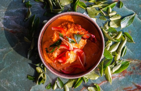 a bowl of food with leaves around it