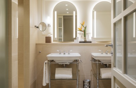 a bathroom with two sinks and a mirror