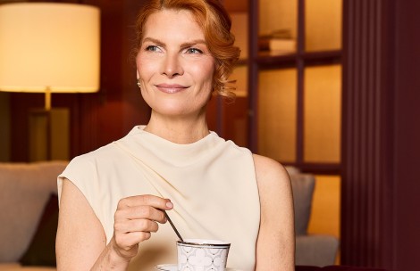 a woman holding a cup of coffee