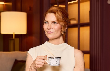 a woman holding a cup