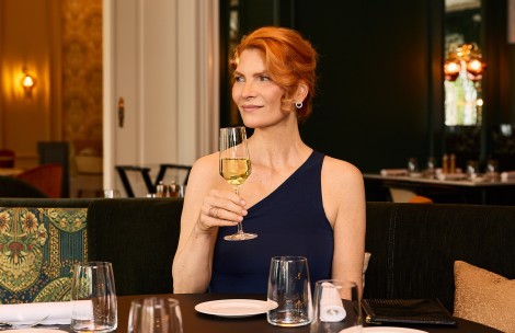 a woman holding a glass of wine