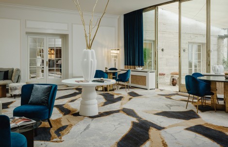 a room with a white table and blue chairs