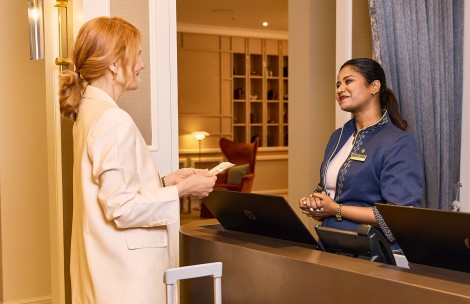 a woman standing next to a woman at a reception