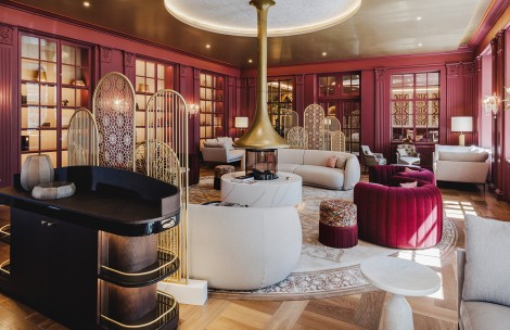 a room with a fireplace and red walls