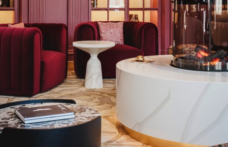 a room with a white table and red chairs