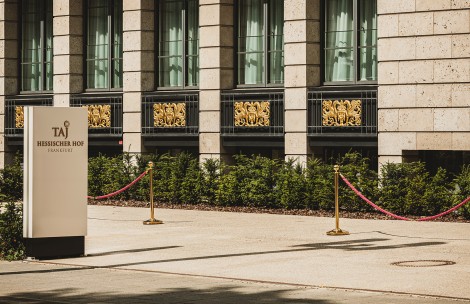 a building with a sign and a red rope