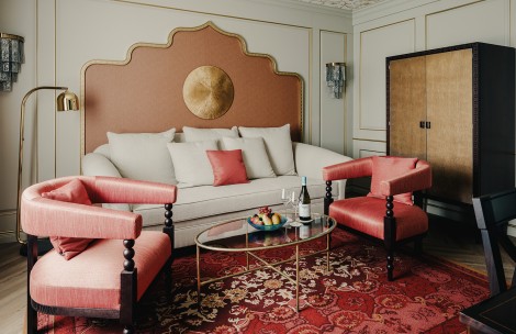 a room with a couch and chairs