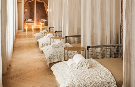 a room with beds and tables