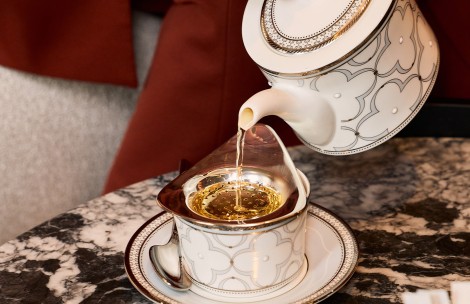 a teapot pouring liquid into a cup