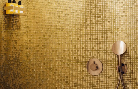 a gold tile wall with a circular object on it
