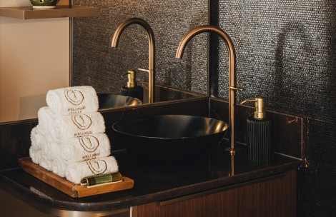a sink with a faucet and a bowl with towels