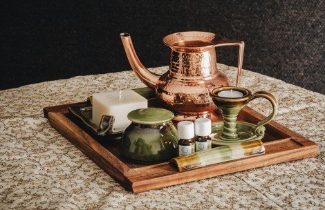 a tray with a candle and a copper kettle on it