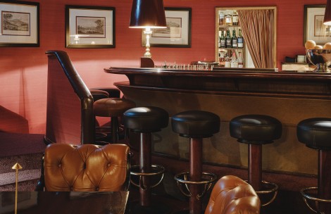a bar with stools and a lamp
