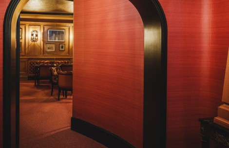 a red wall with a black arch
