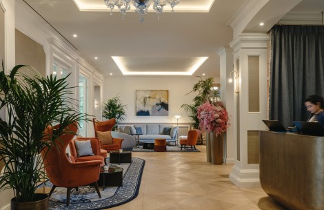 a room with a chandelier and couches