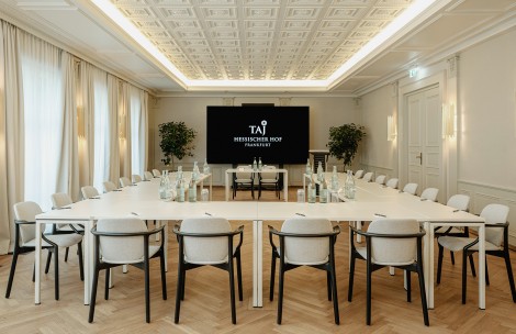 a room with a large table and chairs