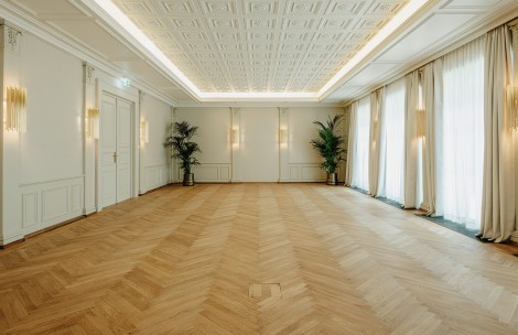 a room with a wood floor and white walls