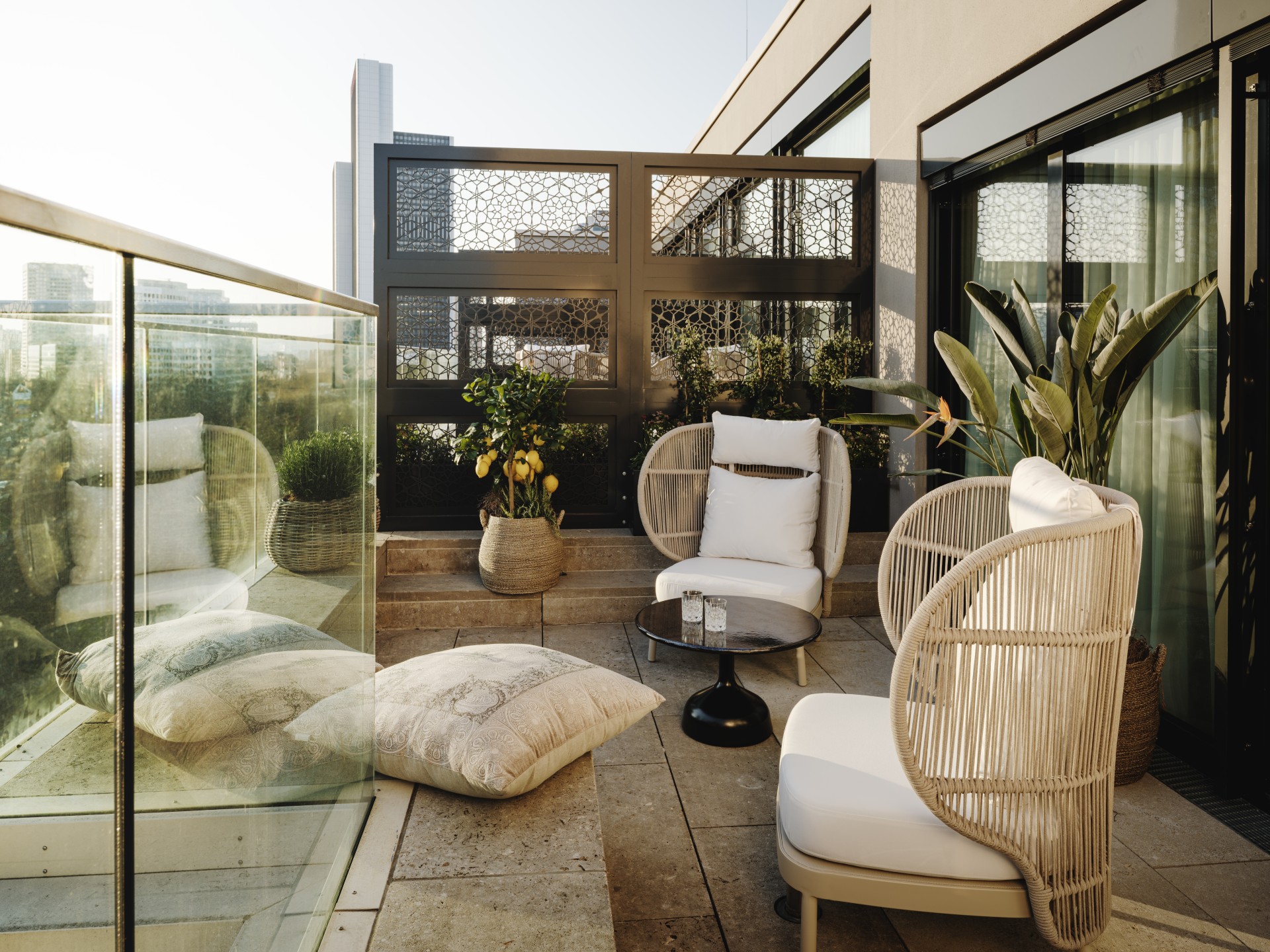 a patio with chairs and pillows