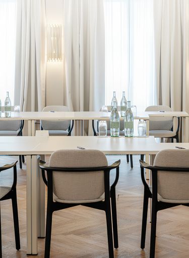 a room with white tables and chairs